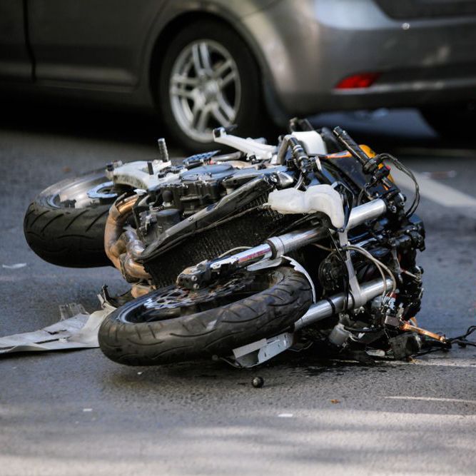 Motorcycle lying on its side on the road after a crash